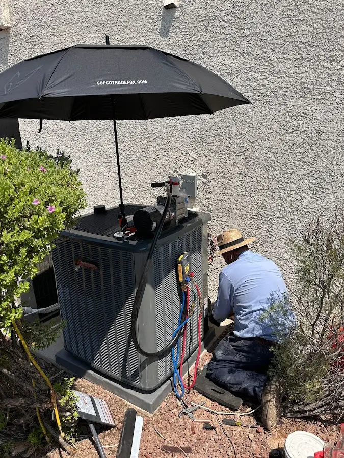 HVAC technician performing outdoor AC maintenance in Porter